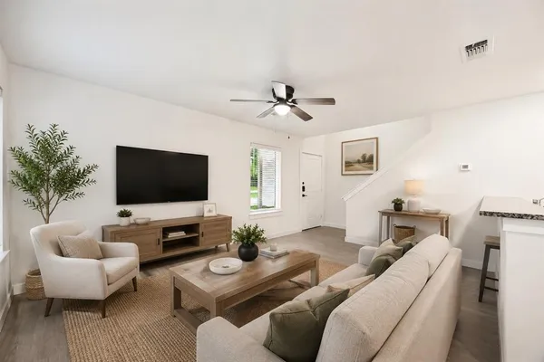 a living room with furniture and a flat screen tv