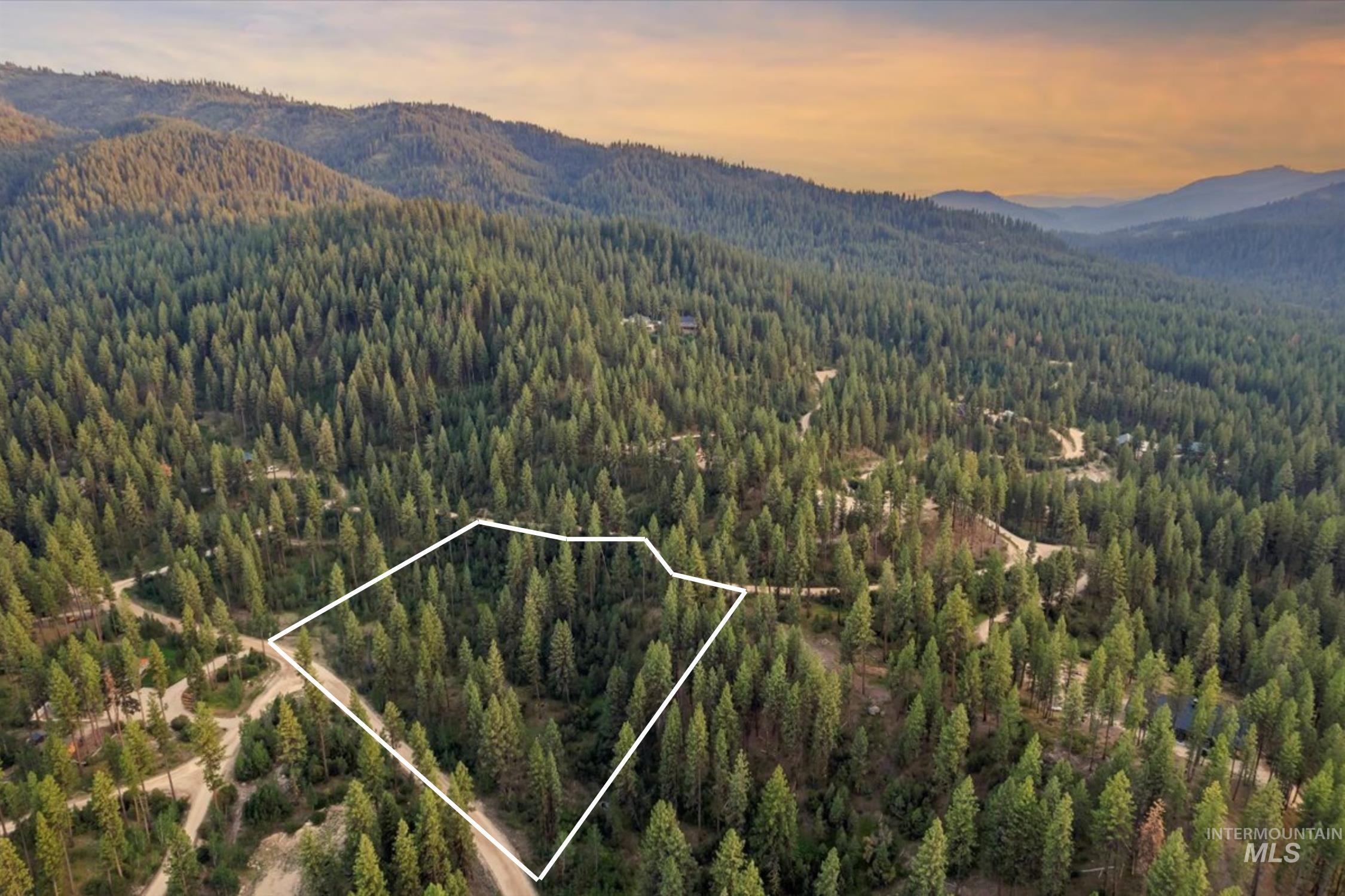 Lot 12 Shaw Gulch Road Boise, ID 83716 - Photo 2 of 23 Aerial view at dusk of a forest view, a mountain view, and property parcel outlined
