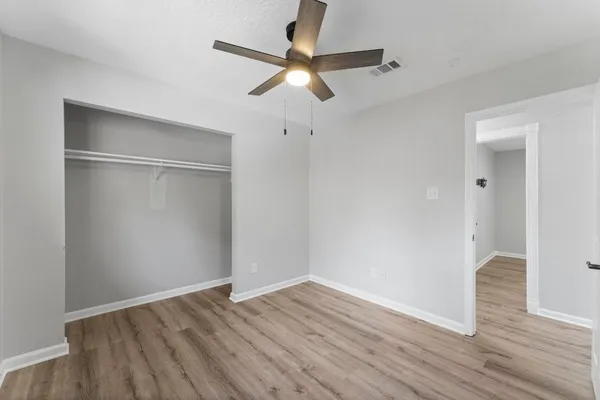 a view of an empty room with wooden floor