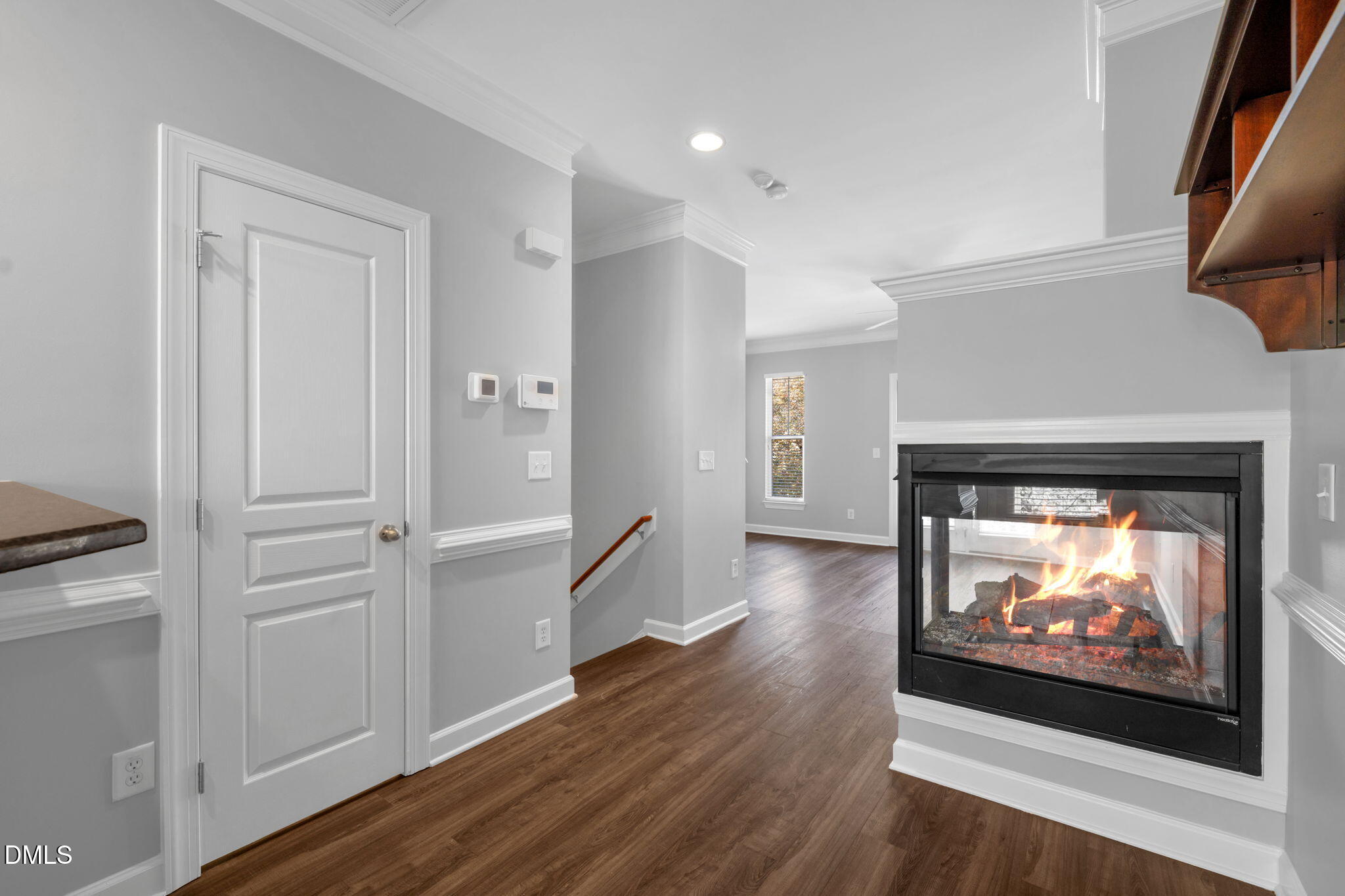 8005 Sycamore Hill Lane Raleigh, NC 27612 - Photo 11 of 31 a view of a living room with wooden floor and a fireplace