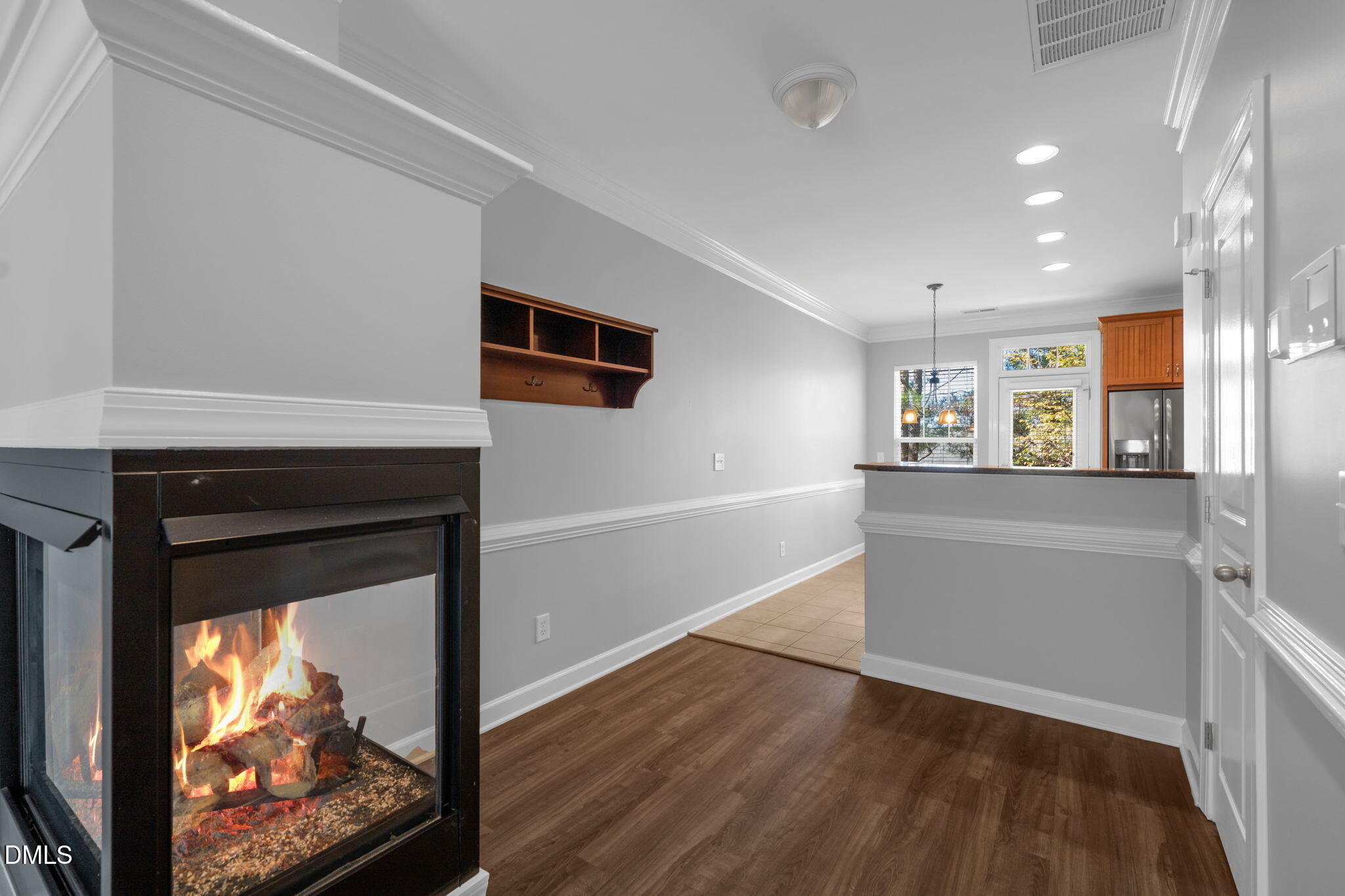 8005 Sycamore Hill Lane Raleigh, NC 27612 - Photo 12 of 31 a living room with stainless steel appliances wooden floor and a fireplace