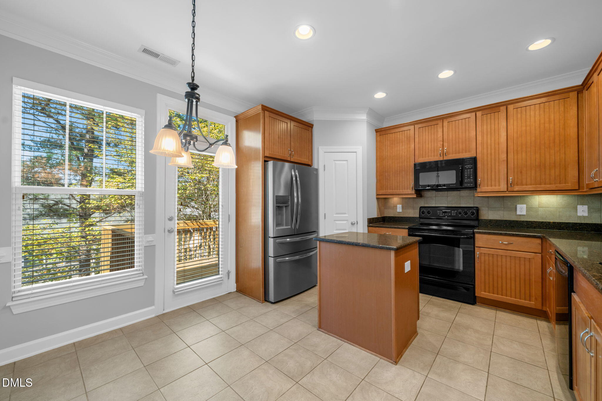 8005 Sycamore Hill Lane Raleigh, NC 27612 - Photo 15 of 31 a kitchen with stainless steel appliances granite countertop a refrigerator a stove top oven a sink and dishwasher