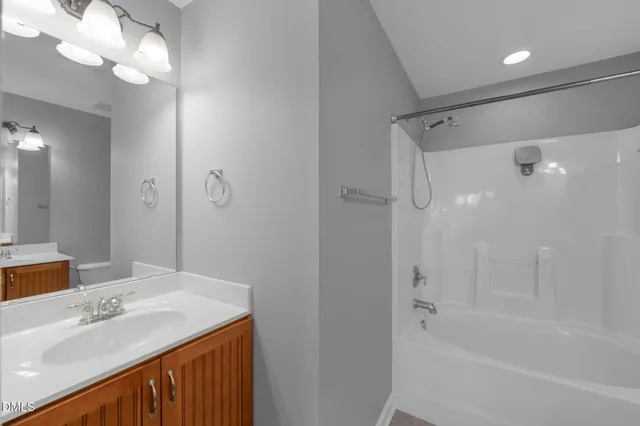 an empty room with chandelier fan and windows