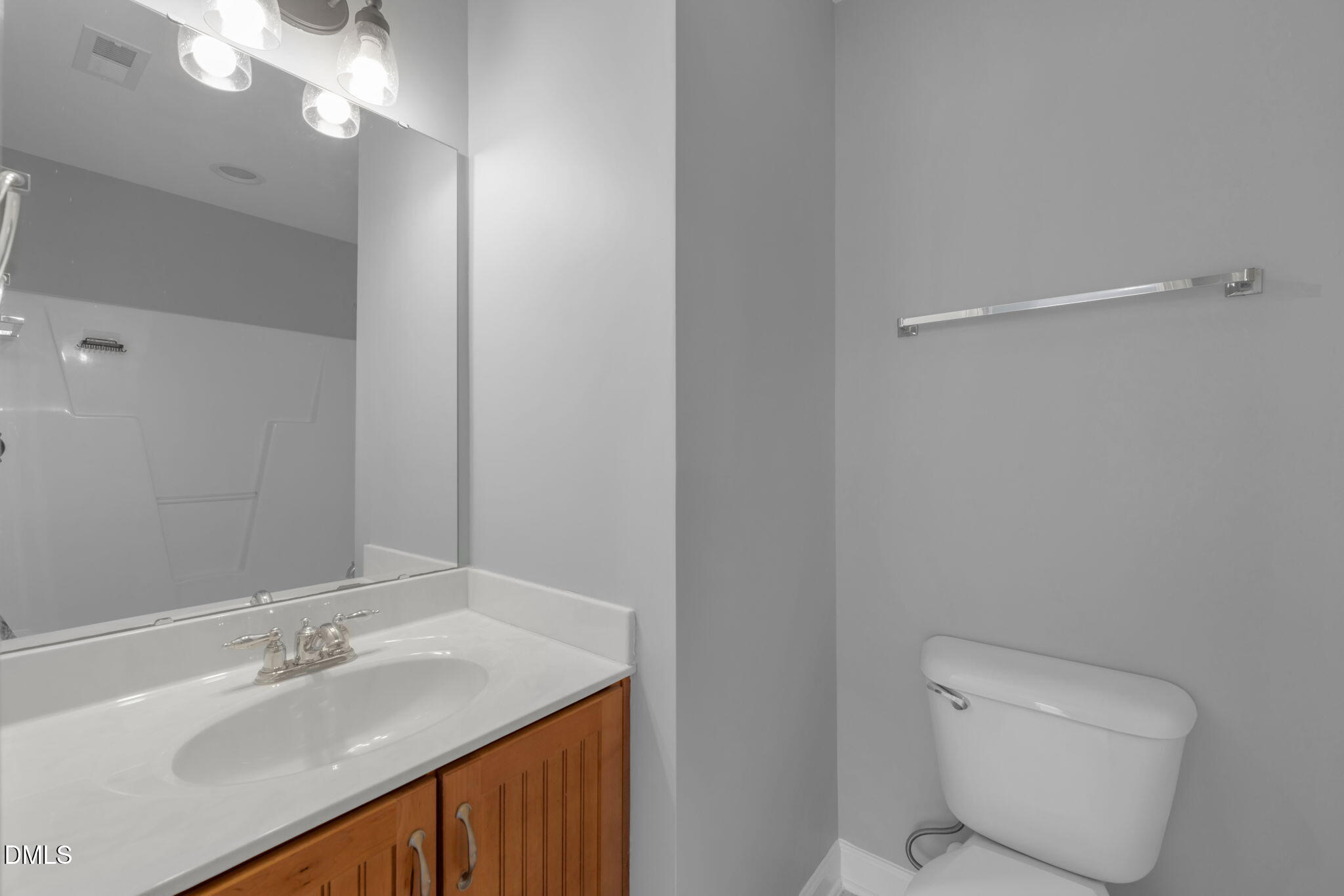 8005 Sycamore Hill Lane Raleigh, NC 27612 - Photo 30 of 31 a bathroom with a sink a toilet and a mirror