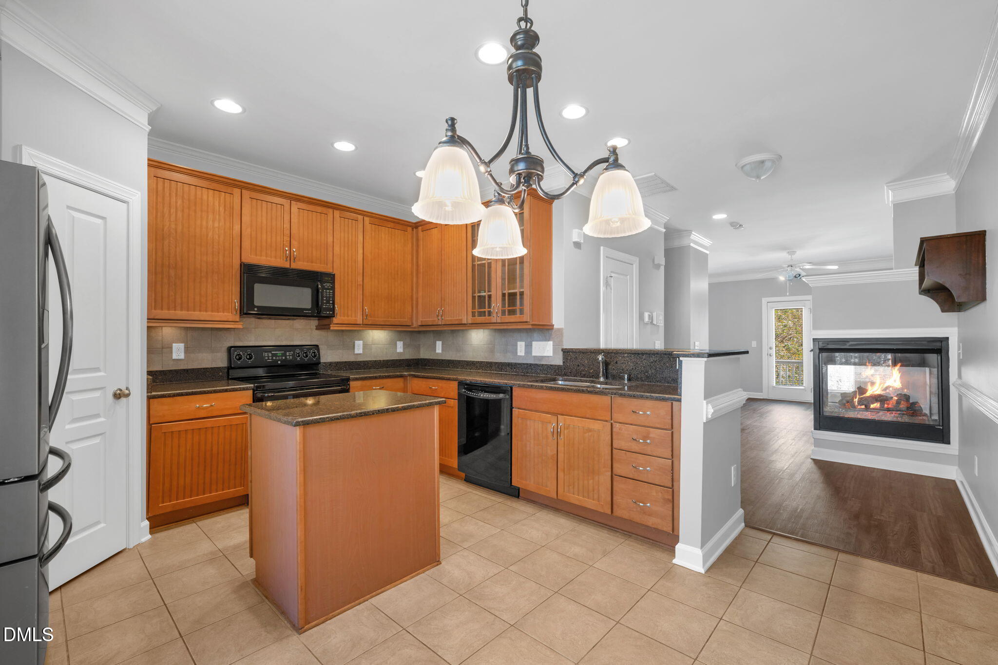 8005 Sycamore Hill Lane Raleigh, NC 27612 - Photo 3 of 31 a kitchen with stainless steel appliances granite countertop a refrigerator a sink a stove top oven and a counter top space