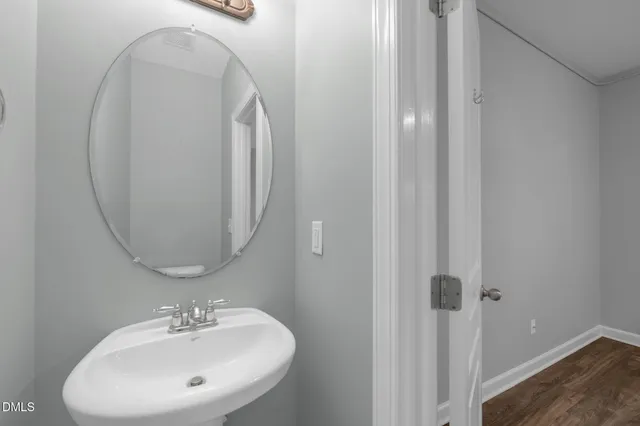 a bathroom with a sink a mirror and shower
