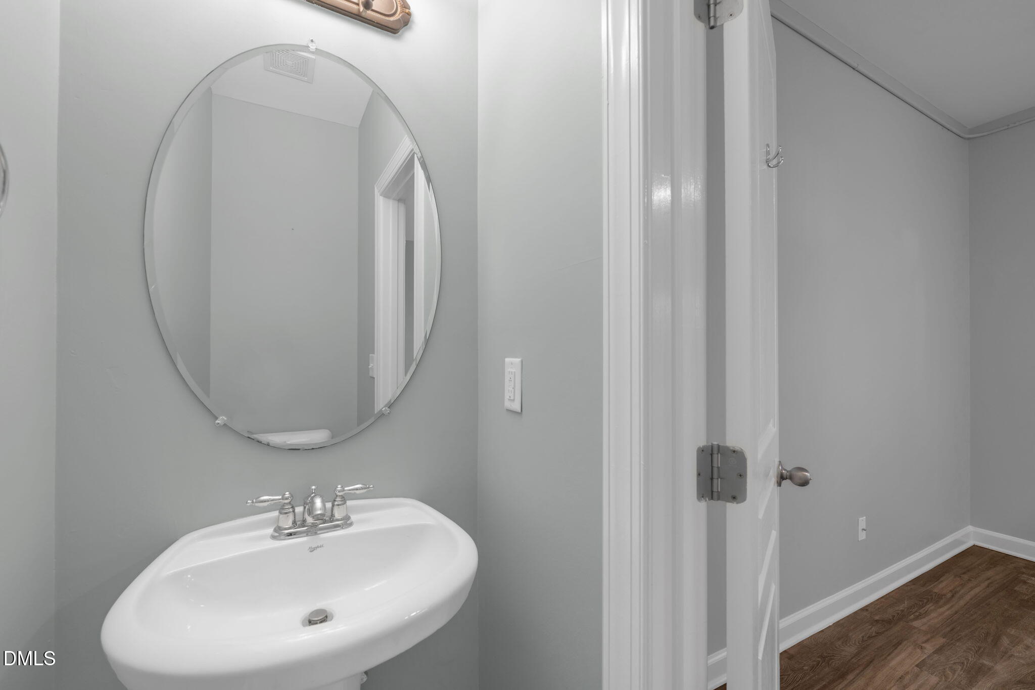 8005 Sycamore Hill Lane Raleigh, NC 27612 - Photo 8 of 31 a bathroom with a sink a mirror and shower