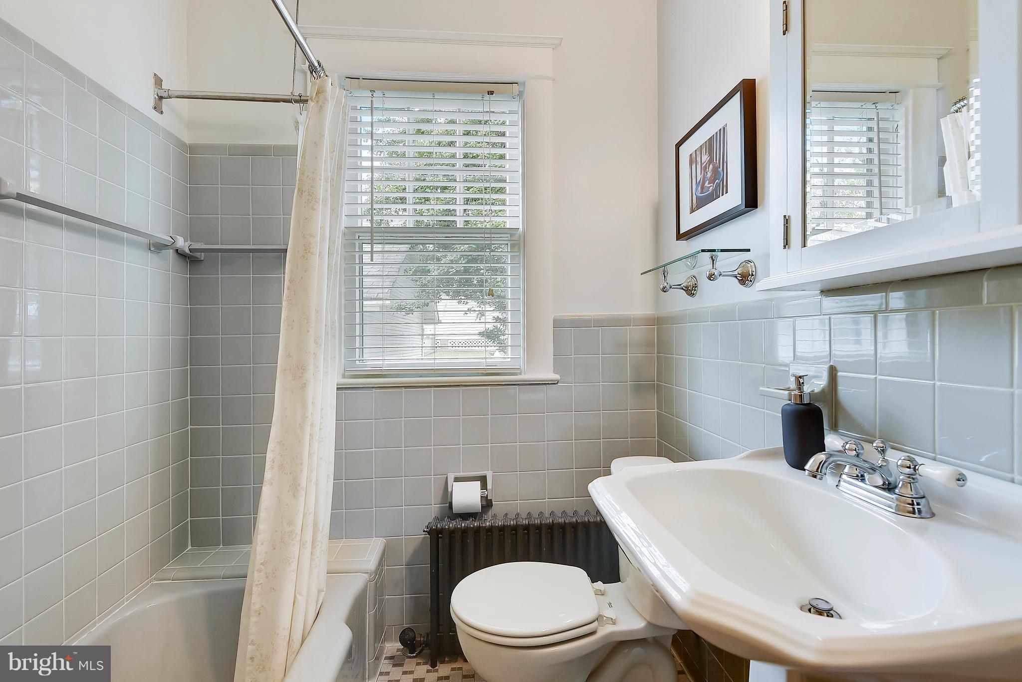 1919 Glen Ross Road Silver Spring, MD 20910 - Photo 23 of 39 a bathroom with a sink a toilet and shower
