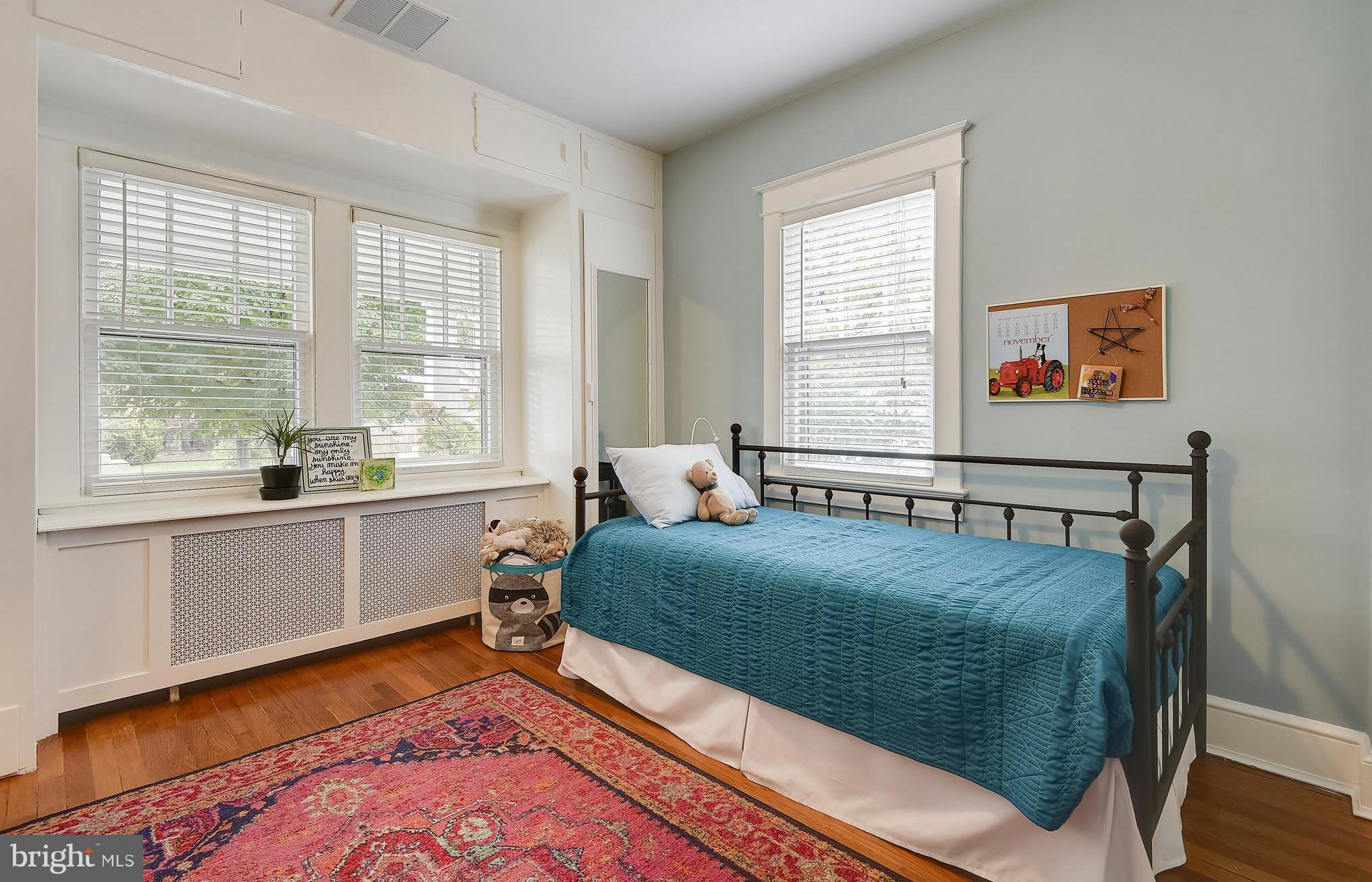 1919 Glen Ross Road Silver Spring, MD 20910 - Photo 25 of 39 a bed sitting in a bedroom next to a window