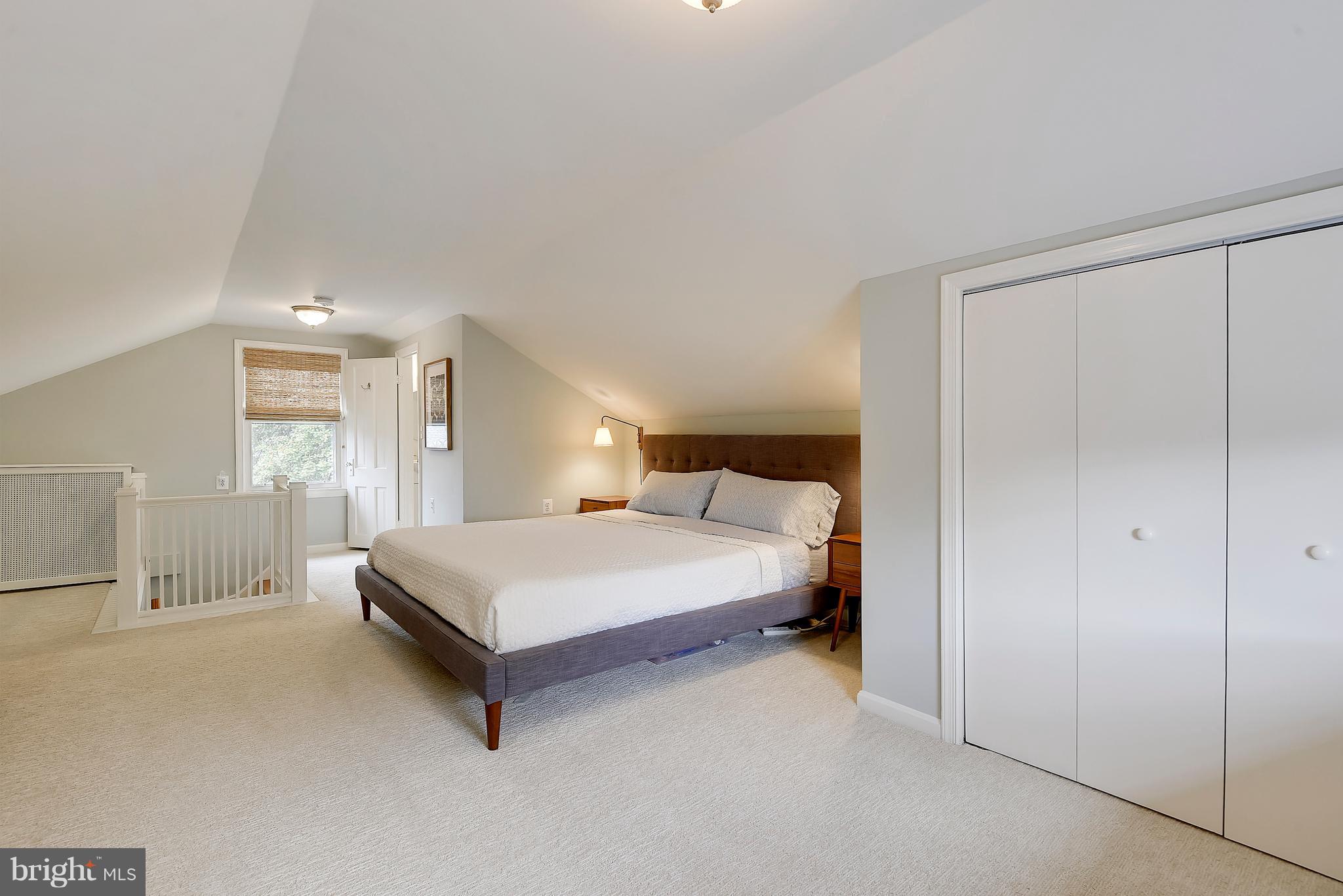 1919 Glen Ross Road Silver Spring, MD 20910 - Photo 29 of 39 a spacious bedroom with a bed and window
