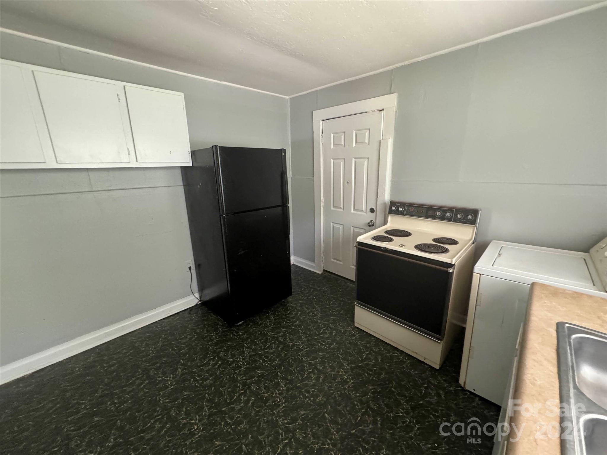 1120 North Ransom Street Gastonia, NC 28052 - Photo 11 of 16 a view of kitchen with refrigerator stove and microwave