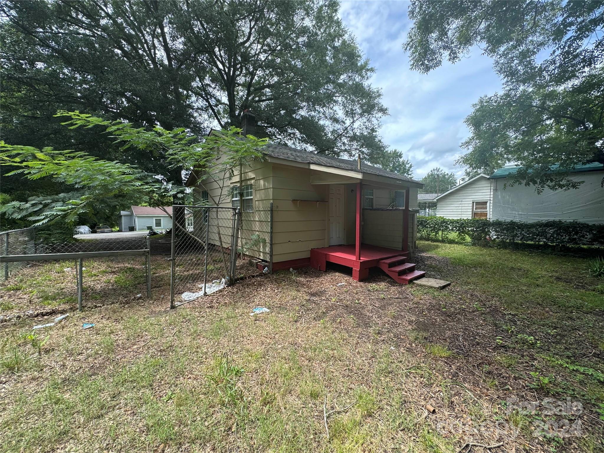 1120 North Ransom Street Gastonia, NC 28052 - Photo 16 of 16 a view of backyard with wooden fence and two large trees