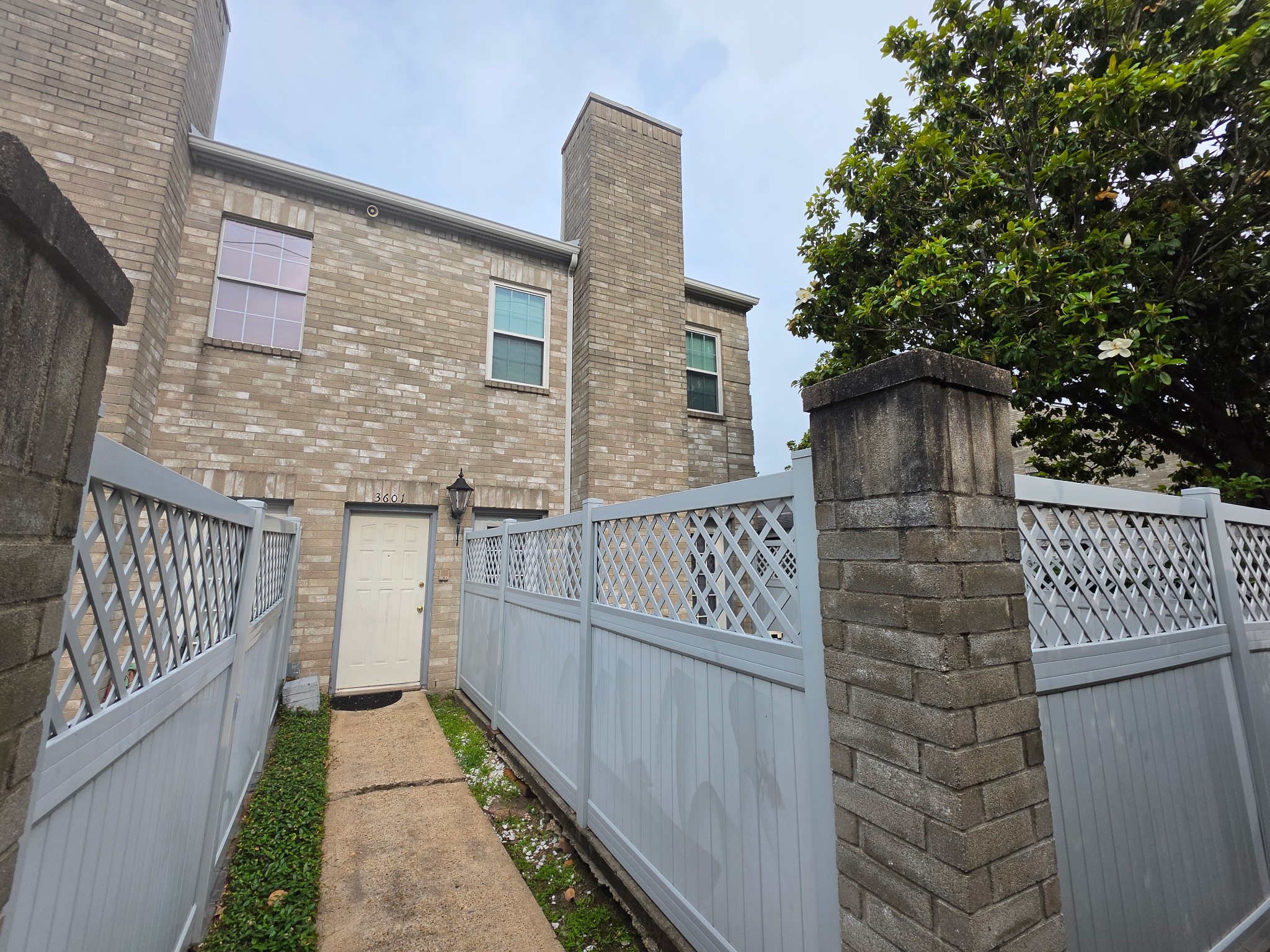 6000 Reims Road, Unit 3601 Houston, TX 77036 - Photo 13 of 13 a brick house with wooden fence and bench
