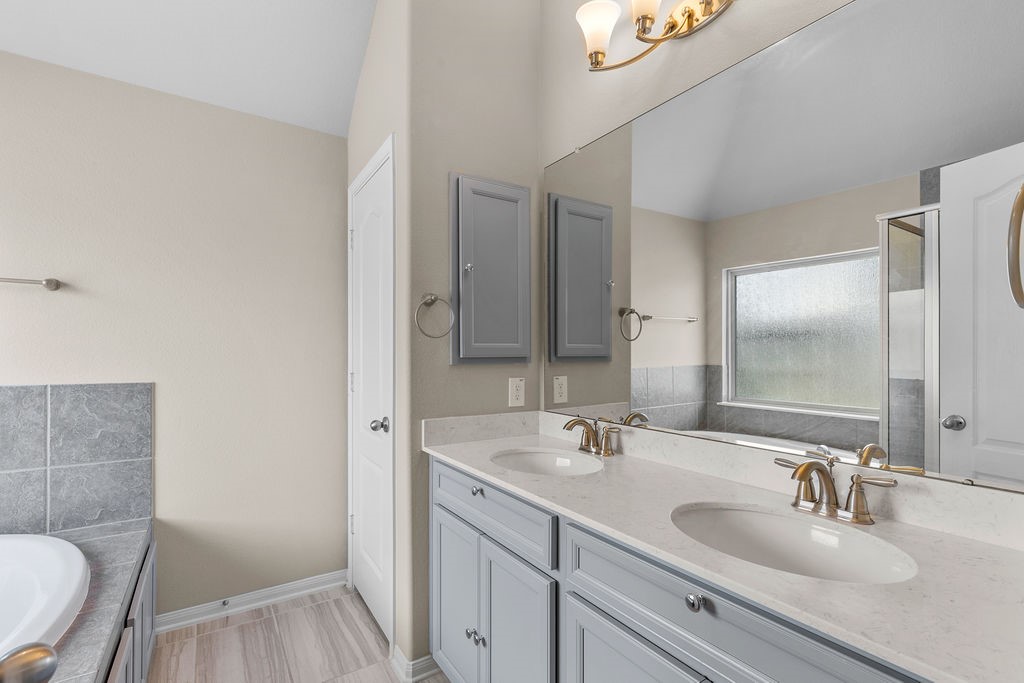 2666 Cedar Path Lane Conroe, TX 77385 - Photo 11 of 22 a bathroom with a sink and a mirror