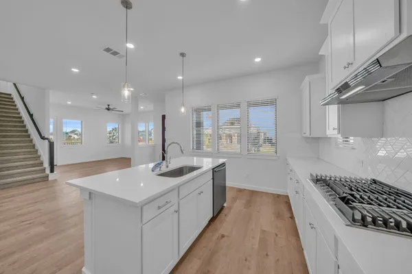 a kitchen with sink and stove