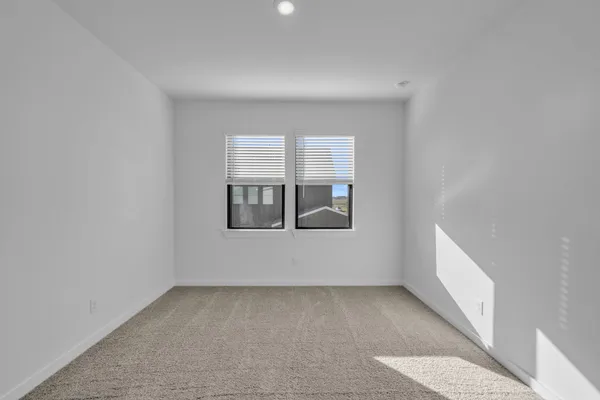 a view of an empty room with windows