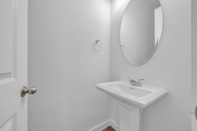 a bathroom with a sink and mirror