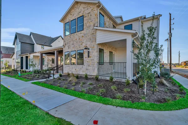 a front view of a house with garden