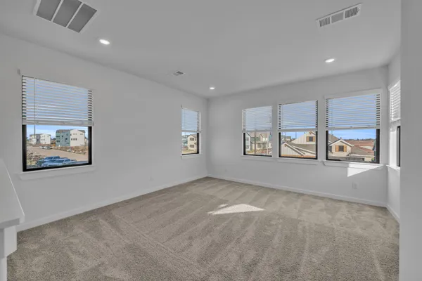 an empty room with windows and closet