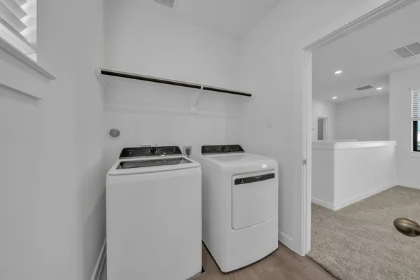 a view of storage and utility room with washer and dryer