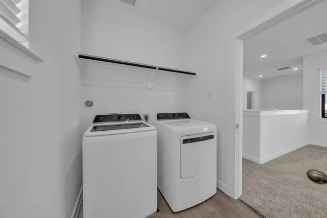 a view of storage and utility room with washer and dryer