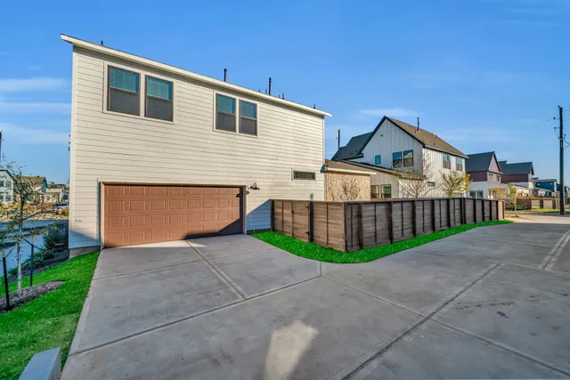 a view of a house with a yard and fence