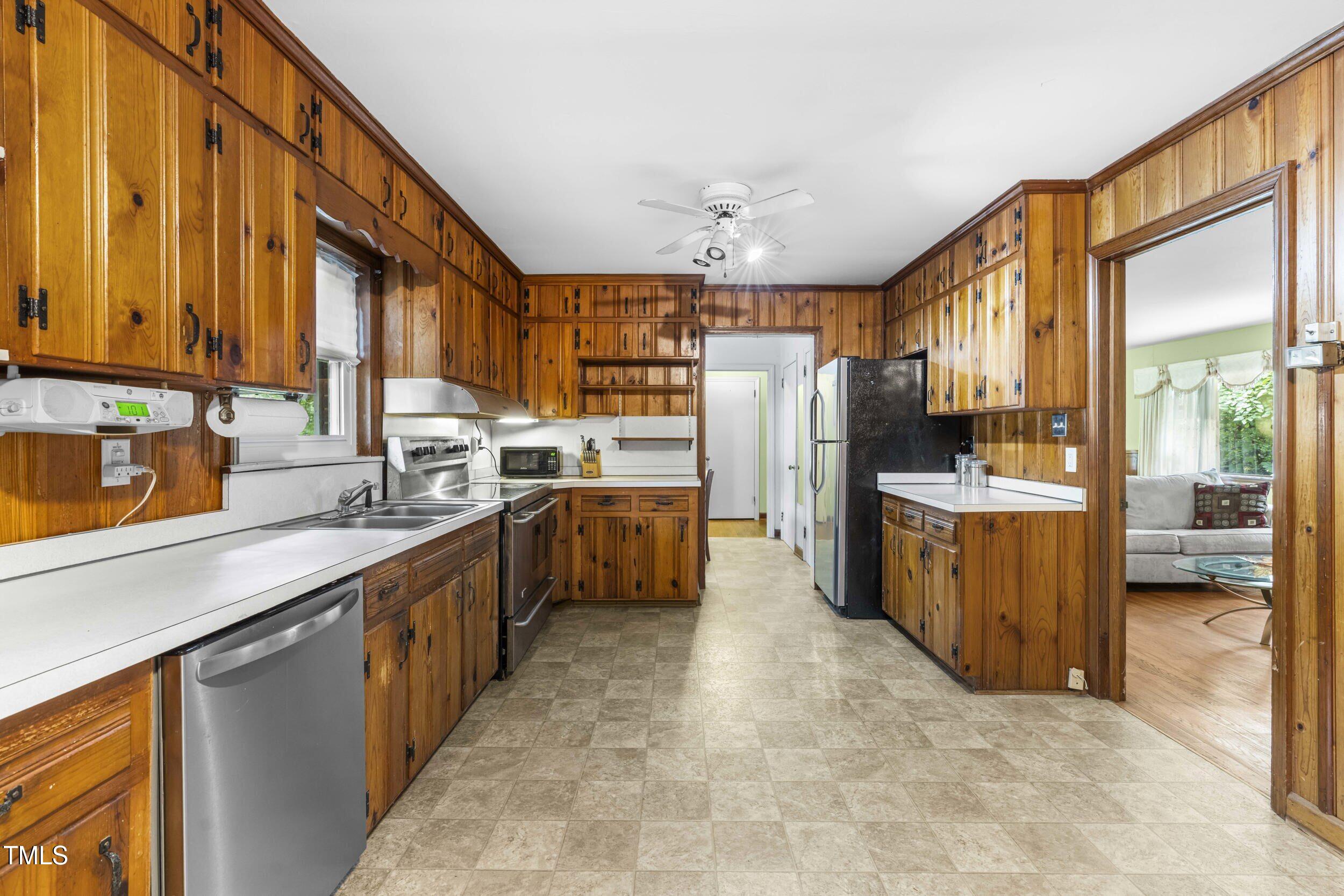 3721 Baugh Street Raleigh, NC 27604 - Photo 2 of 11 a kitchen with refrigerator a sink and cabinets