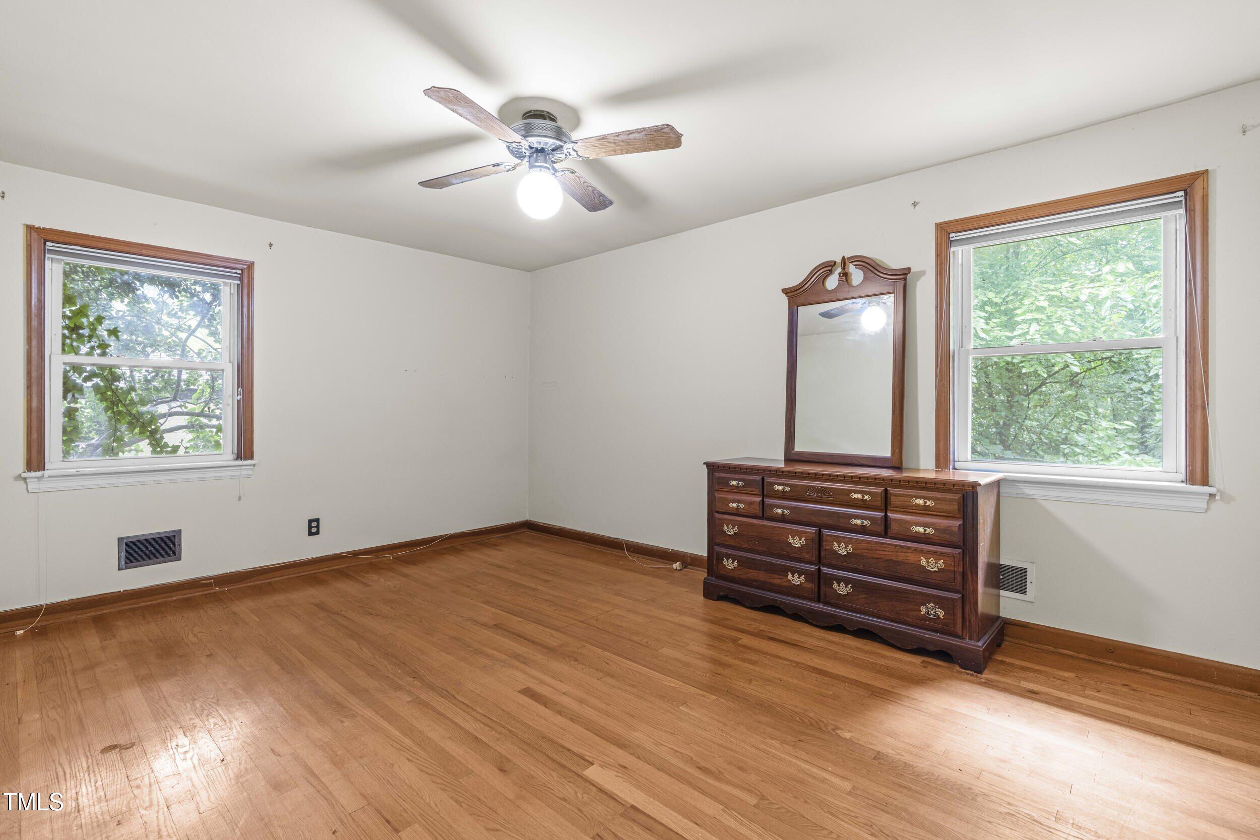 3721 Baugh Street Raleigh, NC 27604 - Photo 6 of 11 wooden floor in an empty room with a window