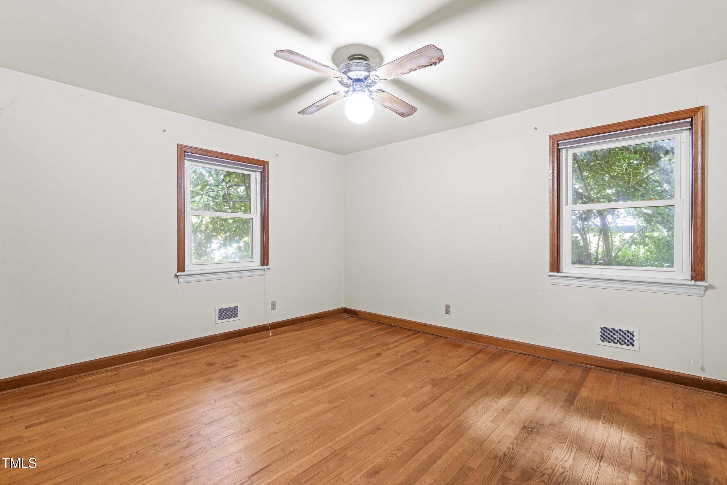 3721 Baugh Street Raleigh, NC 27604 - Photo 7 of 11 wooden floor in an empty room with a window