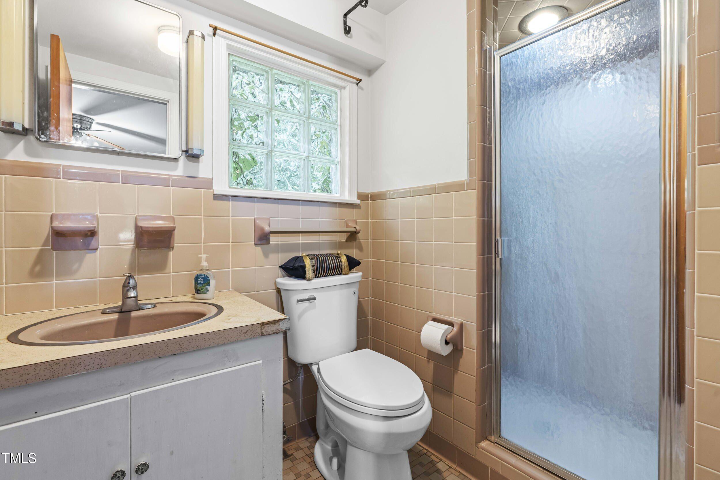 3721 Baugh Street Raleigh, NC 27604 - Photo 9 of 11 a bathroom with a sink toilet and shower