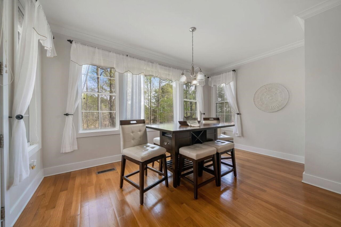 452 Falling Water Road Spring Lake, NC 28390 - Photo 15 of 93 a view of a dining room with furniture window and wooden floor