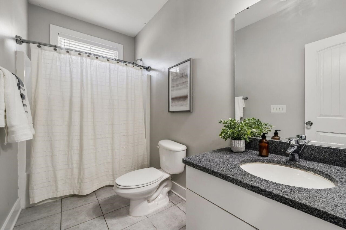 452 Falling Water Road Spring Lake, NC 28390 - Photo 22 of 93 a bathroom with a granite countertop sink toilet and shower