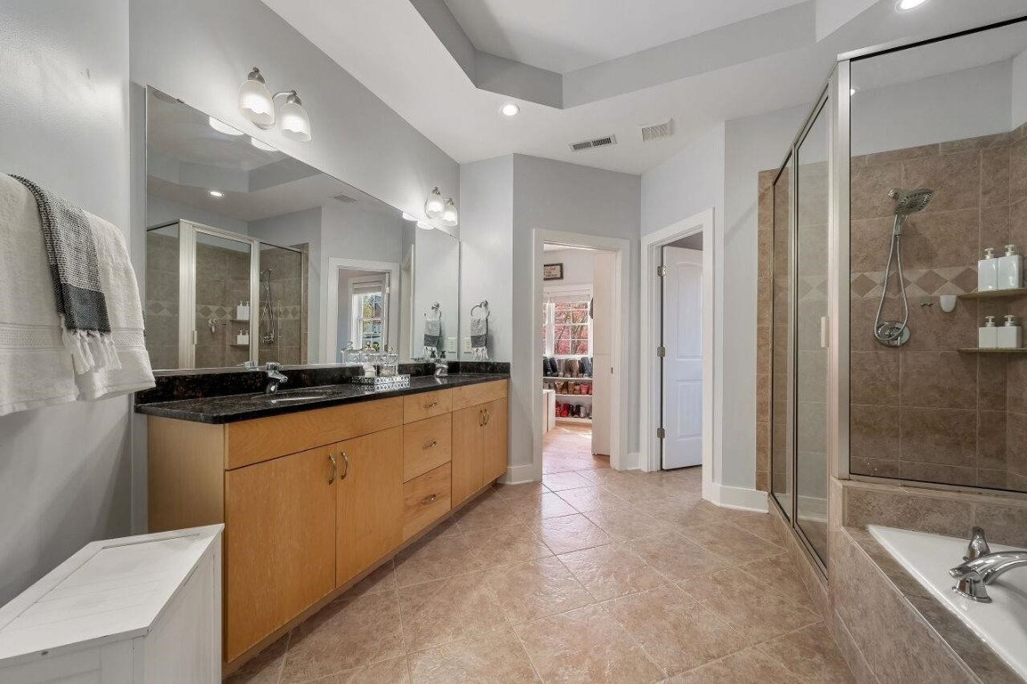 452 Falling Water Road Spring Lake, NC 28390 - Photo 28 of 93 a large bathroom with a large mirror vanity and shower