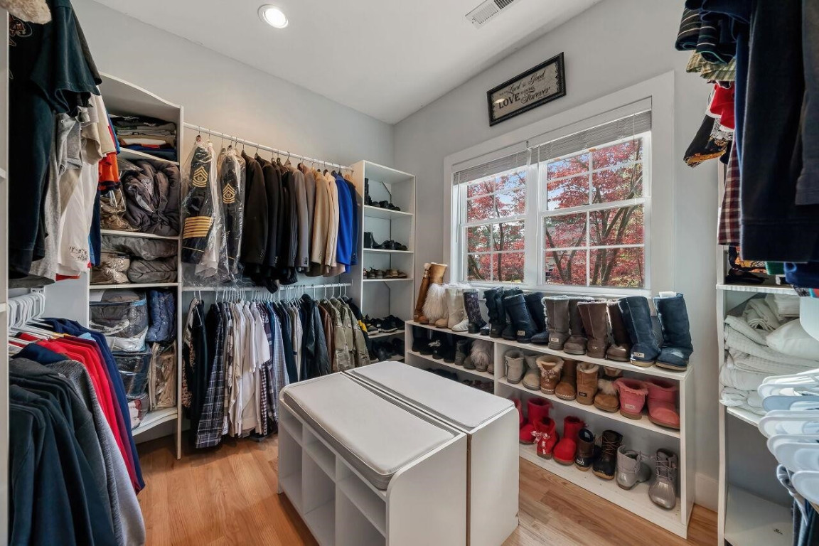452 Falling Water Road Spring Lake, NC 28390 - Photo 29 of 93 a view of walk in closet with clothes and shoes