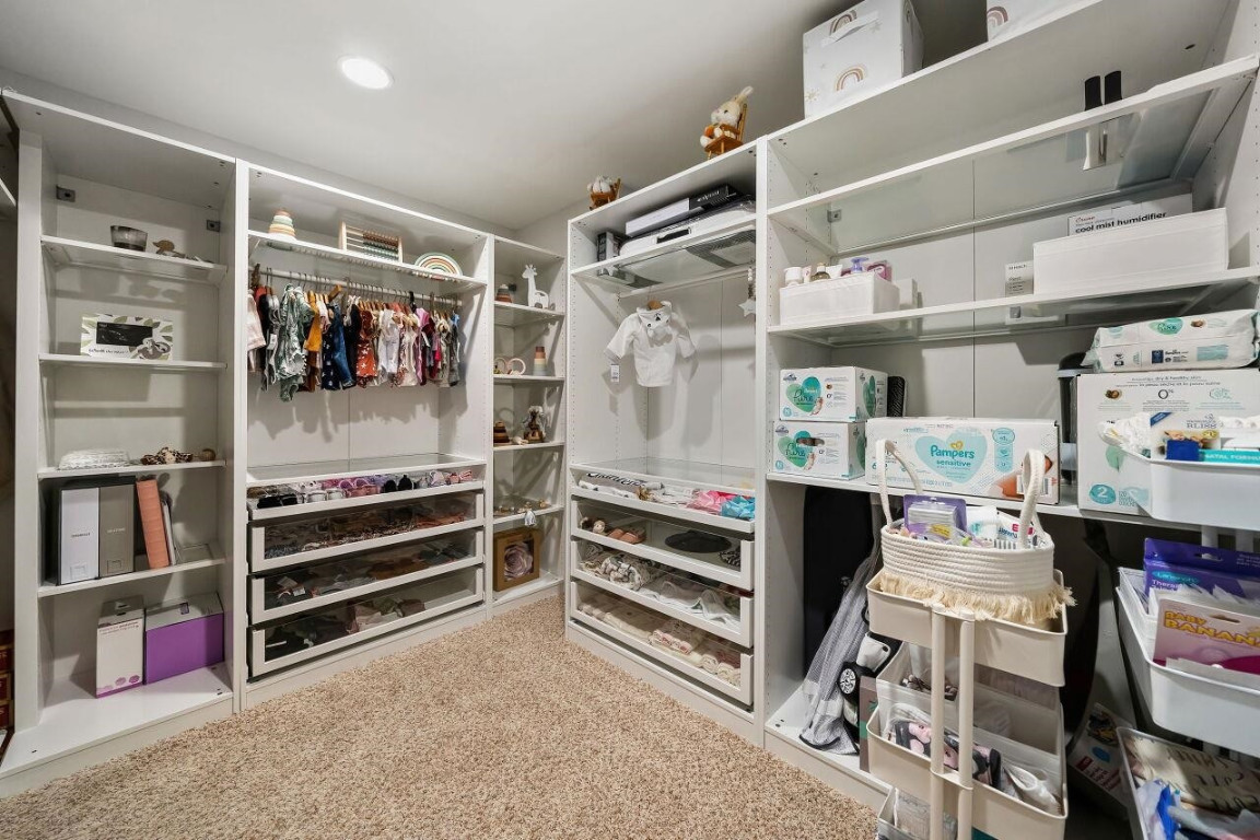 452 Falling Water Road Spring Lake, NC 28390 - Photo 48 of 93 a view of walk in closet with clothes and shoes