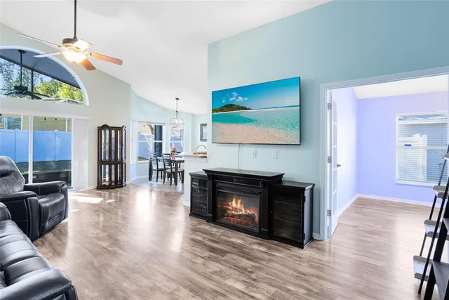 a living room with furniture fireplace and wooden floor
