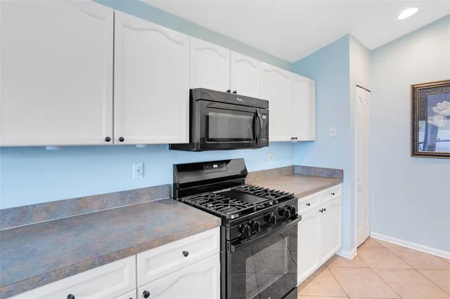 a kitchen with granite countertop cabinets and steel stainless steel appliances