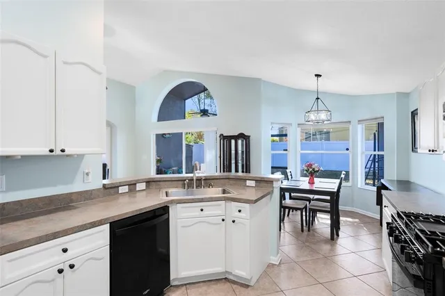 a kitchen with a sink cabinets and window