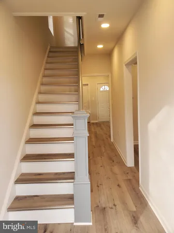 a view of entryway and hall with wooden floor