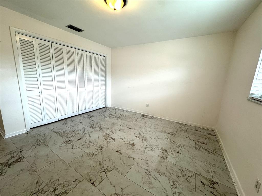 610 Indian Rocks Road North, Unit 103 Belleair Bluffs, FL 33770 - Photo 12 of 13 an empty room with natural light