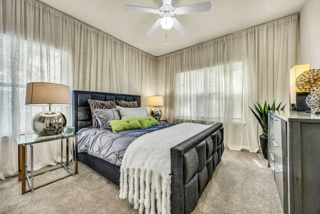 a bedroom with a bed and a chandelier