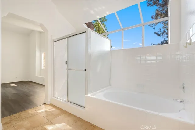 a bathroom with a bathtub and a shower