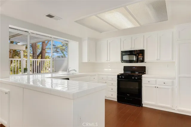 a kitchen with stainless steel appliances granite countertop a stove and a refrigerator