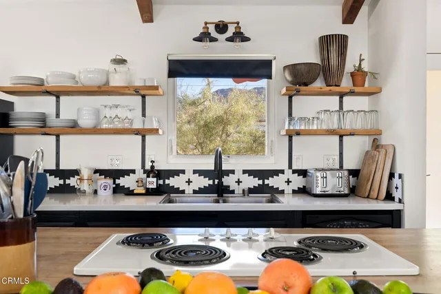 a kitchen with a stove a sink and a microwave