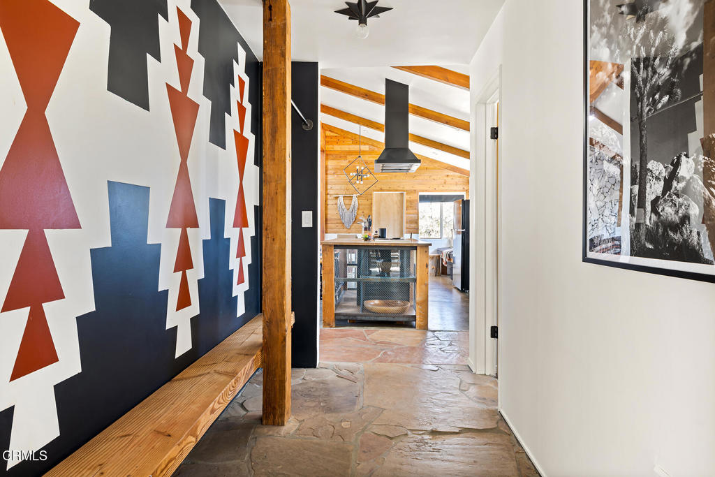 7284 Saddleback Road Joshua Tree, CA 92252 - Photo 12 of 47 a view of a hallway with furniture and a large window