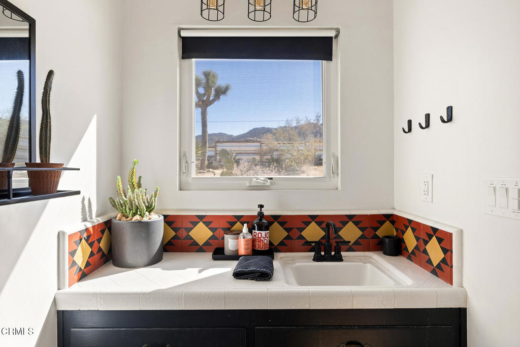 7284 Saddleback Road Joshua Tree, CA 92252 - Photo 16 of 47 a bathroom with a sink and a mirror