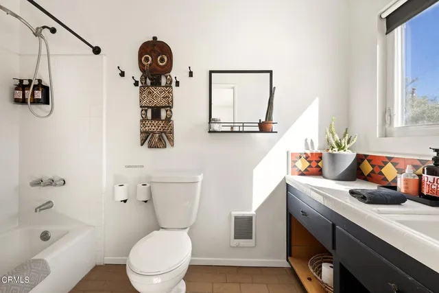 a bathroom with a toilet a sink and a mirror