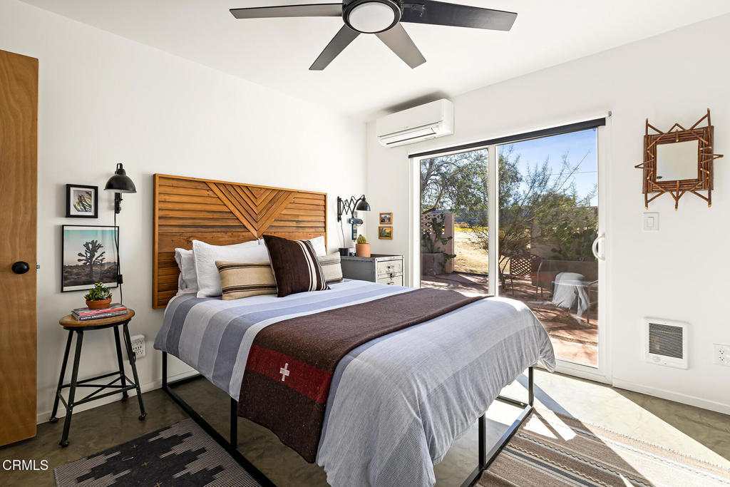 7284 Saddleback Road Joshua Tree, CA 92252 - Photo 18 of 47 a bedroom with a bed and wooden floor