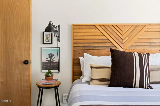 a view of a bedroom with a bed and furniture