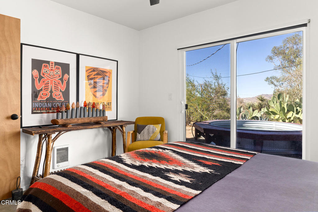 7284 Saddleback Road Joshua Tree, CA 92252 - Photo 22 of 47 a bedroom with furniture and a window